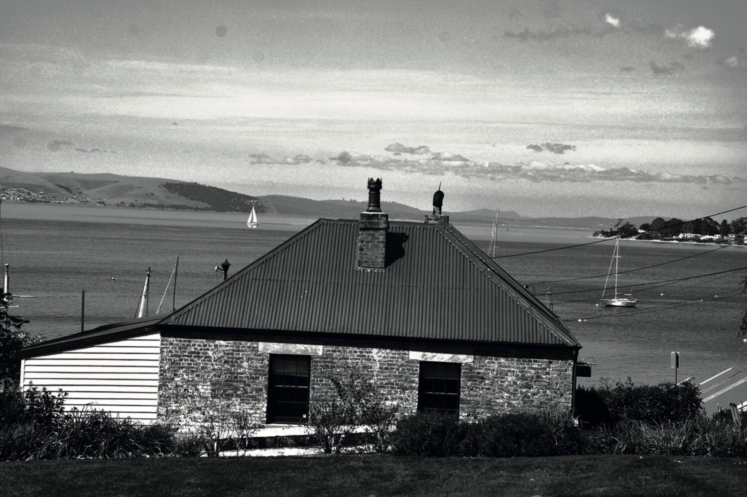 A house with chess like object on top of its chimney facing ocean, a part of ARTISAN Magazine Vol. 3