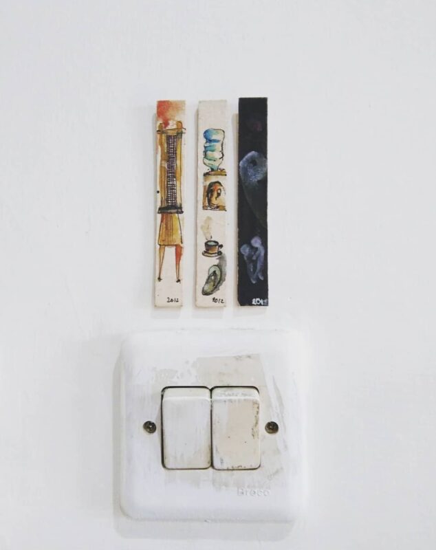 An artwork above lamp switch